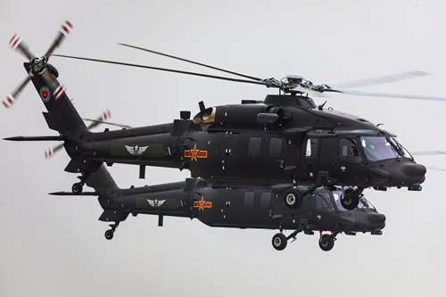 China's Z-20 helicopters fly above the 5th China Helicopter Exposition in Tianjin on Thursday. Photo :AP