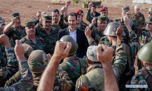 Syrian President Bashar al-Assad (C) visits a military base in the town of Habit in the countryside of Idlib province, Syria, on Oct. 22, 2019. Syrian President Bashar al-Assad met with Syrian soldiers in the country's largest rebel bastion in Idlib province Tuesday, state TV reported. (Syrian Presidency/Handout via Xinhua)