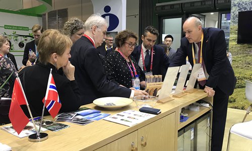 Norwegian Minister of Agriculture and Food Olaug Vervik Bollestad (center) listens to a Norwegian exhibitor introducing the products at the second CIIE. Photo: Courtesy of the Consulate General of Norway in Shanghai