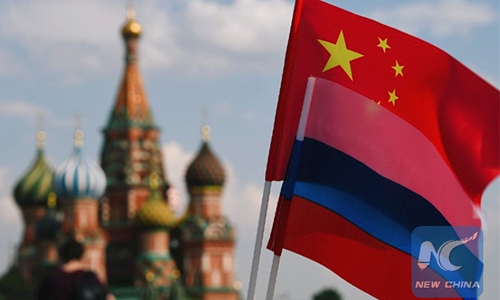 National flags of China and Russia are seen in the Red Square, Moscow, Russia. Photo: Xinhua