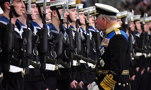 Britain's Prince Charles, Prince of Wales (center) attends the official commissioning ceremony of HMS Prince of Wales in Portsmouth, south England on Tuesday. HMS Prince of Wales is the second of the Royal Navy's QE Class aircraft carriers, built by the Aircraft Carrier Alliance. Photo: AFP