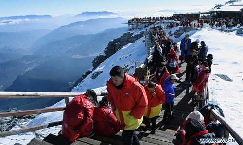 Tourists visit the Yulong Snow Mountain in Lijiang City, southwest China's Yunnan Province, Dec. 10, 2019. (Xinhua/Yang Zongyou)