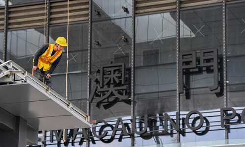 A worker builds the new Hengqin port in Zhuhai, south China's Guangdong Province, Dec. 10, 2019. After three years of construction, the new Hengqin port is ready for visitors to travel between Zhuhai and the Lotus port in Macao. (Photo: Xinhua)
