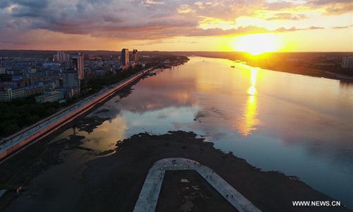 The sunset in Heihe section of the Heilongjiang River in Heihe, northeast China's Heilongjiang Province. (Xinhua/Wang Jianwei)