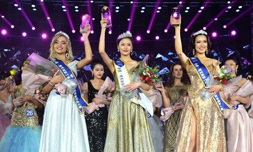 Contestants of an international beauty contest pose for a group photo in Manzhouli, north China's Inner Mongolia Autonomous Region, Dec. 23, 2019, with the first place winner Chinese contestant Zang Xipo (C), the second place winner Mongolian contestant CH_ANUUJIN (R), and the third place winner Russian contestant Golovina Alexandria (L) standing at the front. The final of the 16th China-Russia-Mongolia International Beauty Pageant was held here on Monday. Photo:Xinhua