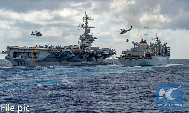 This handout picture released by the U.S. Navy on May 8, 2019 shows the Nimitz-class aircraft carrier USS Abraham Lincoln (CVN 72) while conducting a replenishment-at-sea with the fast combat support ship USNS Arctic (T-AOE 9), while MH-60S Sea Hawk helicopters assigned to the Nightdippers of Helicopter Maritime Strike Squadron (HSM) 5, transfer stores between the ships. Photo:AFP