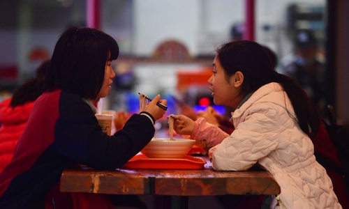 People eat river snail rice noodles at a restaurant in Liuzhou, south China's Guangxi Zhuang Autonomous Region, Jan. 2, 2020. (Xinhua/Huang Xiaobang)