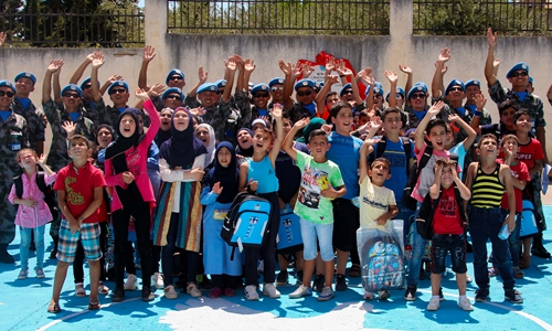 Chinese peacekeepers take a photo with Lebanese students at the newly built 'China-Lebanon Peace Square'.Photo:People's Daily