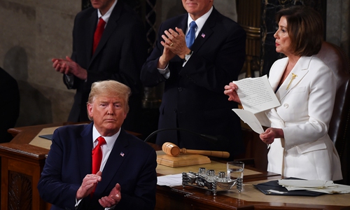 Speaker of the US House of Representatives Nancy Pelosi (right) rips a copy of President Donald Trump's (front) speech after he delivered the State of the Union address at the US Capitol in Washington DC on Tuesday. Photo: AFP