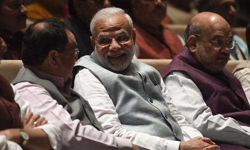 India's Prime Minister Narendra Modi (center) talks with Bharatiya Janata Party (BJP) National President Jagat Prakash Nadda (left) as Home Minister Amit Shah (right) looks on during a BJP parliamentary committee meeting at Parliament House in New Delhi on Tuesday. Phtot: AFP