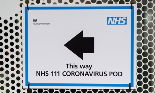 Photo taken on March 2, 2020 shows a sign directing patients to a National Health Service (NHS) 111 Coronavirus Pod positioned at the University College Hospital in London, Britain. (Photo by Ray Tang/Xinhua)
