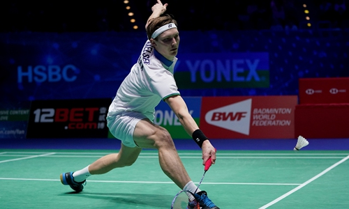 Denmark's Viktor Axelsen hits a return in the final of the men's singles match at the All England Open Badminton Championships in Birmingham, England on Sunday. Photo: VCG
