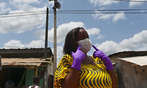 A woman wears a mask in Azaguié Ahoua near Abidjan, Cote d'Ivoire on Friday. 
Photo: AFP