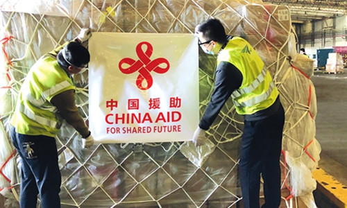 Workers place a banner reading 
