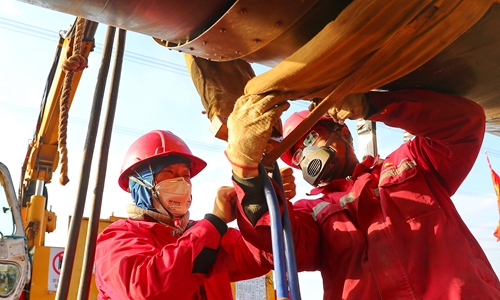 Workers install medium-frequency heating for the China-Russia east-route natural gas pipeline on Wednesday in Qinhuangdao, North China's Hebei Province. The pipeline began operating in December 2019. The project is scheduled to provide China with 5 billion cubic meters of Russian gas in 2020, rising to 38 billion cubic meters annually from 2024. Photo: cnsphotos