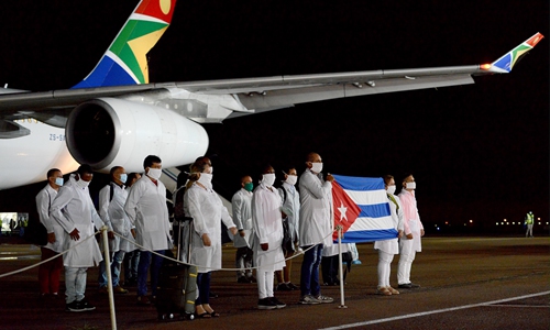 This hand out photo taken and released by DIRCO on Monday shows Cuban Health Specialists arriving at the Waterkloof Air Force Base in Pretoria, South Africa to support efforts to curb the spread of COVID-19. The arrival of the 217 Cuban Health Specialists follows a request made by South African President Cyril Ramaphosa to Cuban President Miguel Díaz-Canel. Photo: AFP