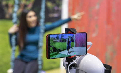 The PowerEgg X autonomous personal AI camera tracks a woman on a swing at the 2020 Consumer Electronics Show (CES) in Las Vegas, the US on January 9. Photo: AFP