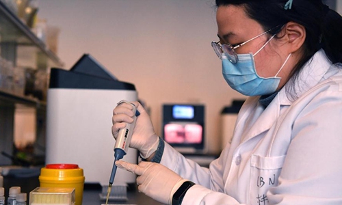A staff checks the nucleic acid test kit at the plant of Luoyang Ascend Biotechnology Co., Ltd in Luoyang, central China's Henan Province, March 4, 2020. Photo: Xinhua
