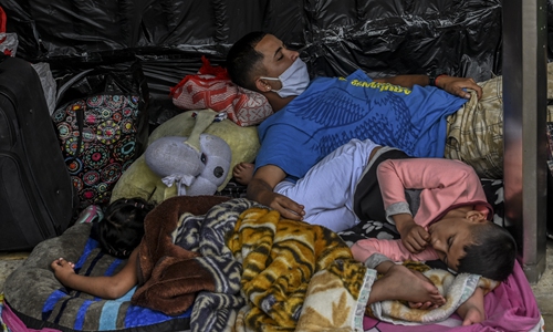 Venezuelan migrants wanting to return to their country due to the COVID-19 pandemic, camp outside the bus terminal in Medellin, Colombia on Tuesday, hoping to board a bus to reach the border. Photo: AFP