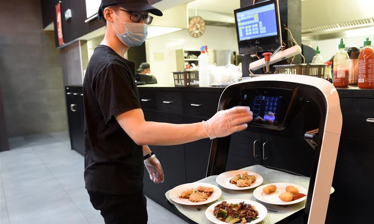 Robot delivers meals to customer at Asian restaurant in Vienna, Austria