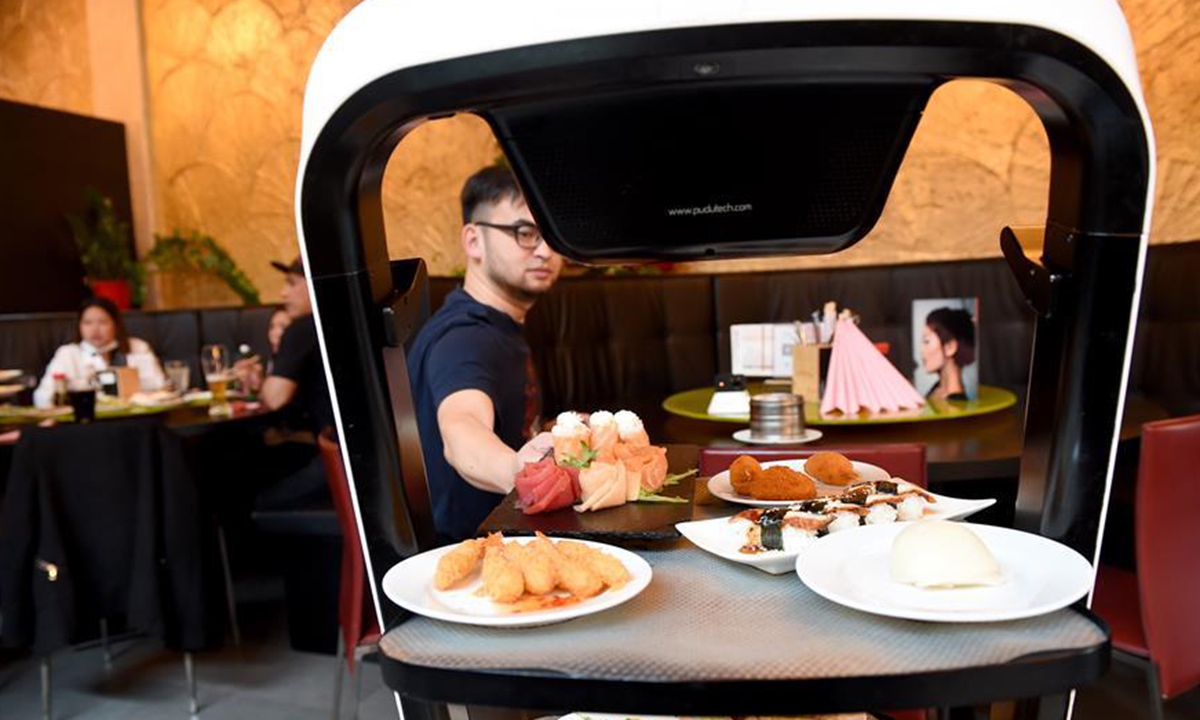 Robot delivers meals to customer at Asian restaurant in Vienna, Austria