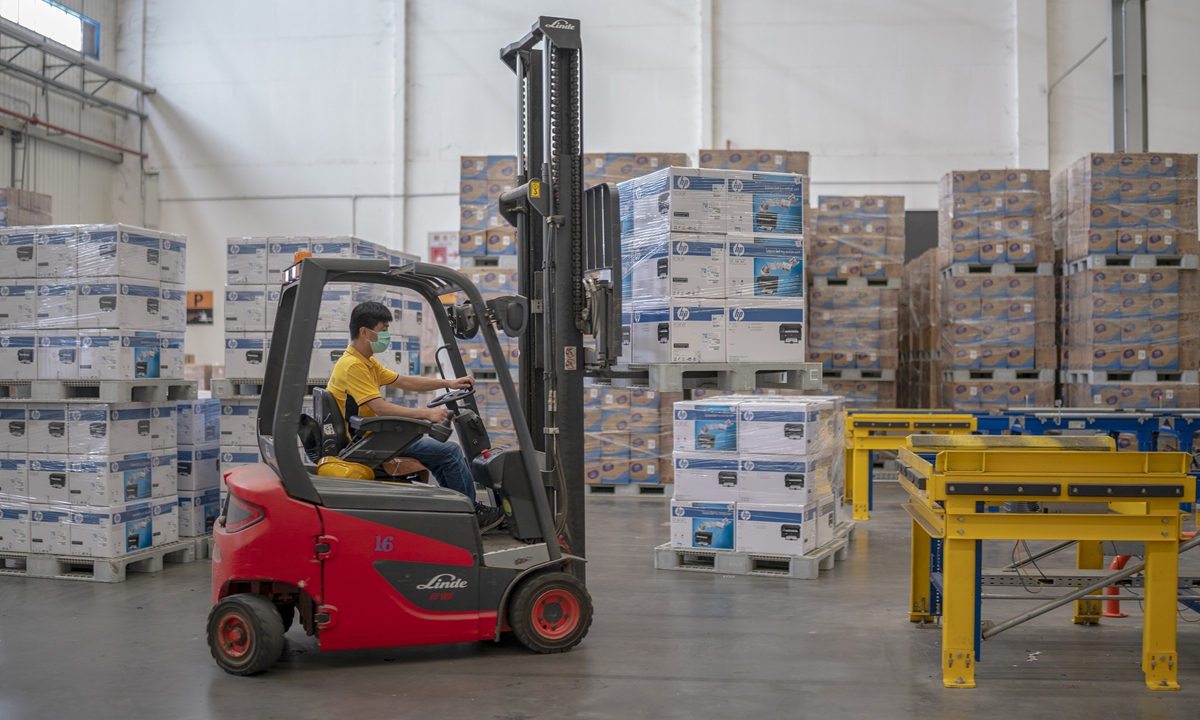 A worker drives a forklift in a logistics sorting center in Nanjing, East China's Jiangsu Province on Thursday. With the