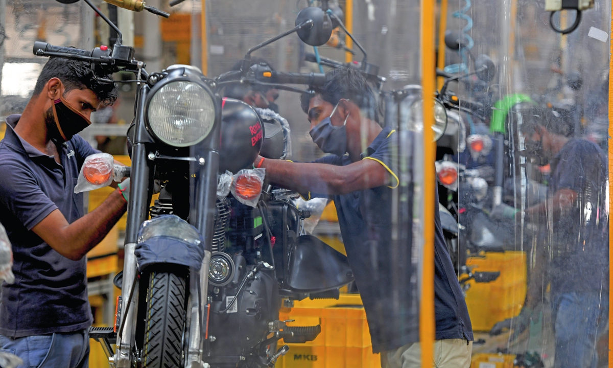 Workers assemble Royal Enfield motorcycles at a factory in Oragadam, India on Tuesday after the government eased nationwide lockdown measures aimed at preventing the spread of COVID-19. Photo: AFP