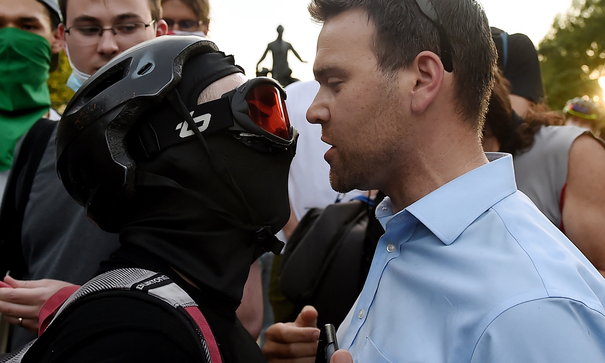 Conservative activist and US President Donald Trump supporter Jack Posobiec (right) gets into an argument with anti-racism protesters in front of the Emancipation Memorial at Lincoln Park in Washington, DC on Friday. Photo: AFP