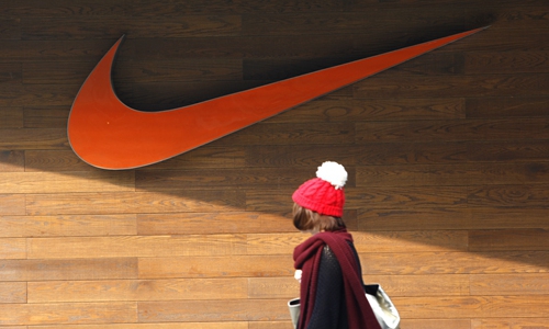 A pedestrian passes by a Nike store in Beijing. Photo: cnsphoto