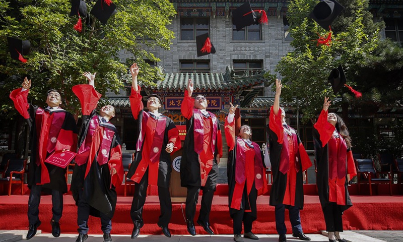 Graduates celebrate their graduation after the commencement ceremony of the Peking Union Medical College in Beijing, capital of China, June 30, 2020. (Xinhua/Zhang Yuwei)