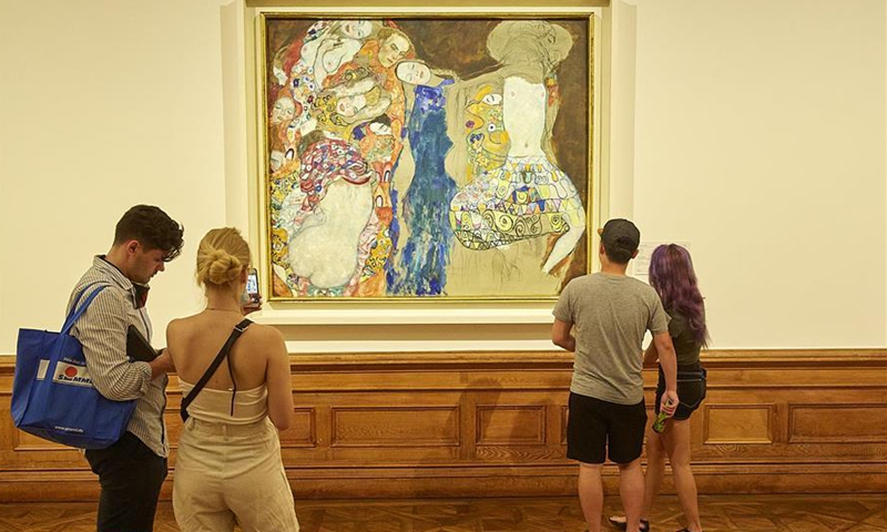 People view The Bride by Gustav Klimt at the Upper Belvedere in Vienna, Austria, on July 1, 2020. The Upper Belvedere reopened to visitors on Wednesday after a temporary closure due to the COVID-19 pandemic. (Photo by Georges Schneider/Xinhua)
