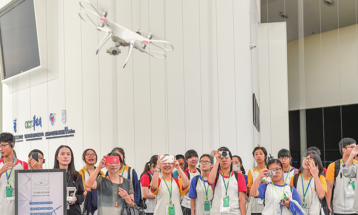 Students and teachers from Hong Kong visit a DJI flagship shop in Shenzhen, South China's Guangdong Province during a tour to witness the achievements of China's reform and opening-up in June 2018. Photo: Xinhua
