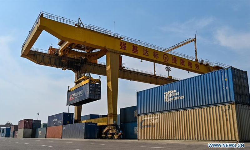 A crane loads containers at the Manzhouli Railway Station in Manzhouli, north China's Inner Mongolia Autonomous Region, April 13, 2020. Manzhouli, the largest land port on the China-Russia border, saw a rising number of China-Europe freight trains during the first quarter this year. The number of freight trains that ran between China and Europe via Manzhouli went up 8 percent year on year to 591, transporting a total of 52,947 standard containers of cargo in the period. (Xinhua/Yu Jia)