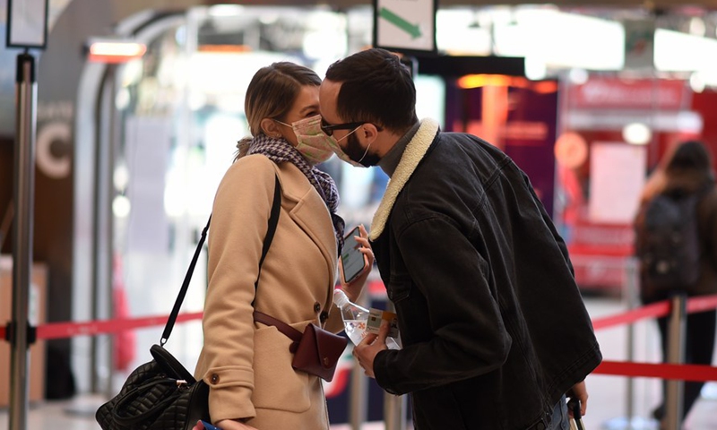 People wearing masks kiss each other at Milan Central Railway Station in Milan, capital city of Lombardy region, Italy, March 8, 2020. (Photo by Danie