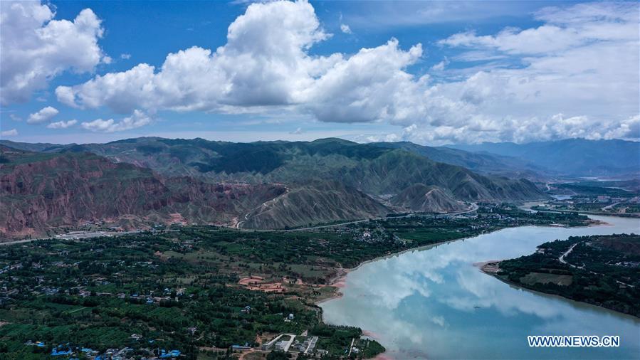 Aerial photo taken on July 10, 2020 shows the landscape at a section of the Yellow River in Hualong Hui Autonomous County in Haidong City, northwest China's Qinghai Province. As the local ecological environment improved in recent years, more and more land along the river here has been covered in lush green vegetation. (Xinhua/Wu Gang)


