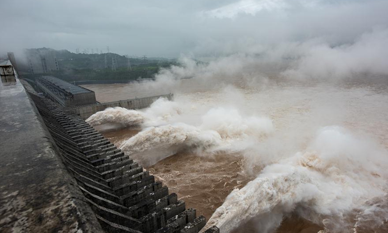 Photo taken on July 18, 2020 shows the Three Gorges Dam opening the floodgates to discharge the floodwater on the Yangtze River in central China's Hubei Province. The Three Gorges reservoir in central China's Hubei Province has seen the second flood along the Yangtze River in 2020, the largest one arriving at the reservoir so far this year. At 8 a.m. on Saturday, the inbound flow of water reached 61,000 cubic meters per second while the outbound flow was 33,000 cubic meters per second, with 45 percent of floodwater withheld in the reservoir, according to the China Three Gorges Corporation.Photo:Xinhua