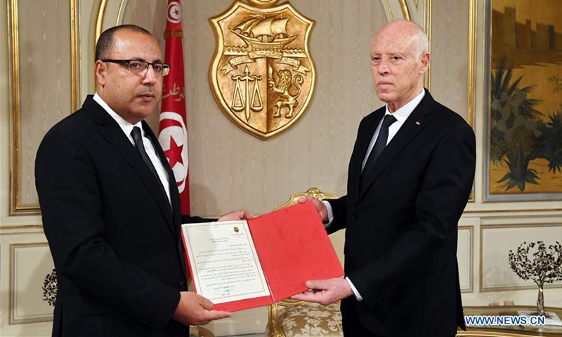 Tunisian President Kais Saied (R) assigns the current interior minister Hichem Mechichi to form a new government, in Tunis, Tunisia, July 25, 2020. (Tunisian Presidency/Handout via Xinhua)
