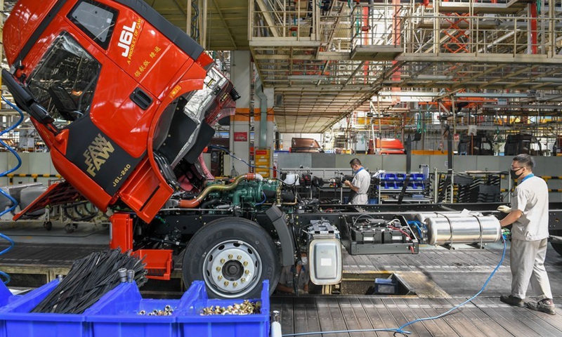 Employees assemble vehicles at a workshop of China FAW Group in Changchun, capital of northeast China's Jilin Province, June 19, 2020. (Photo: Xinhua) 