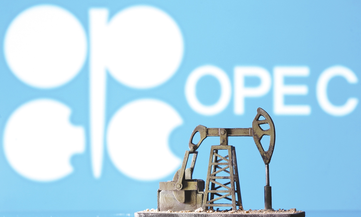 A 3D printed oil pump jack is seen in front of the displayed OPEC logo on April 14. Illustration: VCG