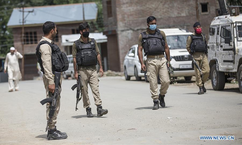 Policemen stand guard after a local level leader of India's ruling Bhartiya Janta Party (BJP) was killed at village Vessu in Kulgam district, about 70 km south of Srinagar city, the summer capital of Indian-controlled Kashmir, Aug. 6, 2020. Unidentified gunmen believed to be militants Thursday shot dead a local level leader of the BJP in restive Indian-controlled Kashmir, police said. The slain leader identified as Sajad Ahmad Khanday was attacked outside his residence at village Vessu. (Xinhua/Javed Dar)