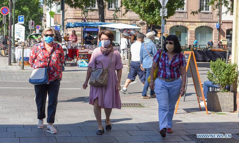 People wearing face masks tour central Strasbourg, eastern France, on Aug. 5, 2020. The French authorities have ordered people to wear face masks in outdoor public places in many major cities as the COVID-19 spread faster and the admission to intensive care units increased again after month-long decline. (Photo by Genevieve Engel/Xinhua) 