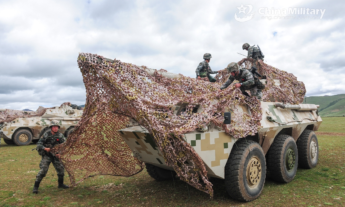 Artillerymen apply camouflage nets to wheeled assault guns Global Times