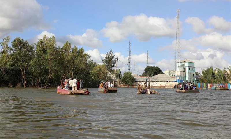 People row through a flooded road in Afgoye, Somalia, Aug. 9, 2020. More than 150,000 Somalians have fled their homes since June due to flash and riverine flooding in the southern regions of this Horn of Africa nation, Farhan Haq, deputy spokesman for UN Secretary-General Antonio Guterres, told journalists at a virtual press briefing on Friday. (Photo by Hassan Bashi/Xinhua) 