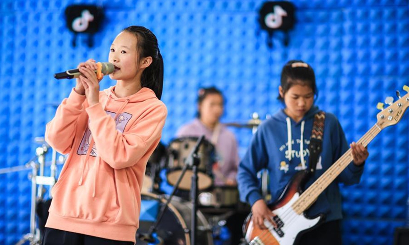 Vocalist Yan Xingli (1st L) and bassist Luo Chunmei (1st R) of student band Encounter rehearse for a live concert at Haiga Primary School in Dawan Township of Liupanshui, southwest China's Guizhou Province, Aug. 18, 2020. The live concert was given on Wednesday evening by two student bands at Haiga Primary School, Encounter and Unknown Teenagers, in collaboration with Chinese band New Pants. Haiga Primary School is located on Jiucaiping Mountain, which is 2,400 meters above sea level. Its two student bands were born in 2018 and consist of young music lovers at different ages, and they became skilled musicians under proper instruction. As their instructor Gu Ya puts it, music is indeed one of the best heart-purifiers for the students, although it won't necessarily improve their material circumstances. According to video-sharing platform Douyin, Wednesday's live concert has attracted 142 million viewers online. (Xinhua/Liu Xu)
