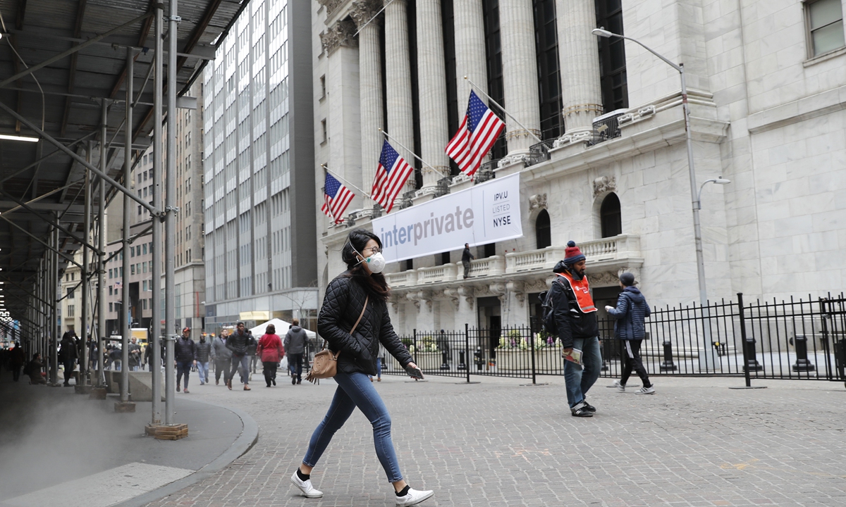 Passengers walk through New York stock exchange in March. Photo: CNSphoto