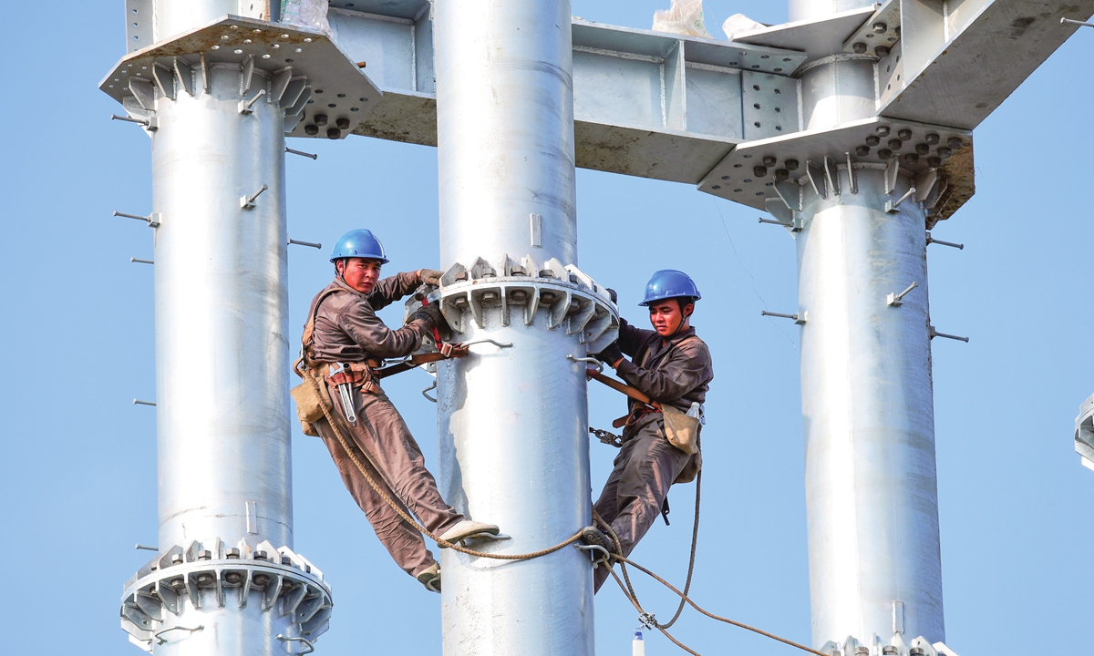 Workers assemble a tower foundation for a new power transmission line in Huangjing town, East China's Jiangsu Province on Tuesday. The line requires the building of 66 tower foundations, and it will ease power shortages in the town. Photo: cnsphoto
