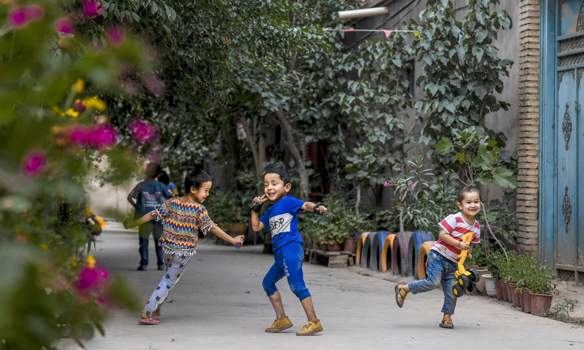 Children have fun in an alley at Qianjin Village in Kashgar, northwest China's Xinjiang Uygur Autonomous Region, Aug. 18, 2019. Photo: Xinhua