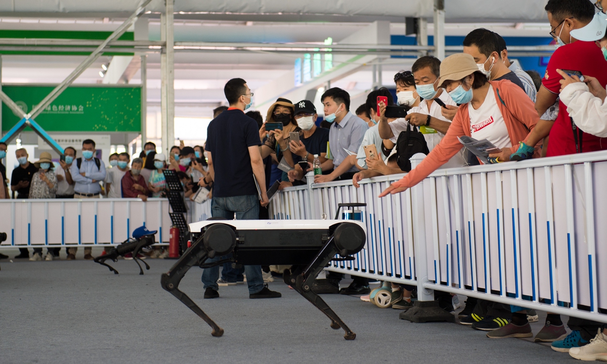 Visitors interact with a robot dog at the China International Fair for Trade in Services (CIFTIS) on Tuesday. The 2020 CIFTIS in Beijing is the first major international economic and trade event held both online and in person by China since the COVID-19 outbreak. Photo: cnsphoto