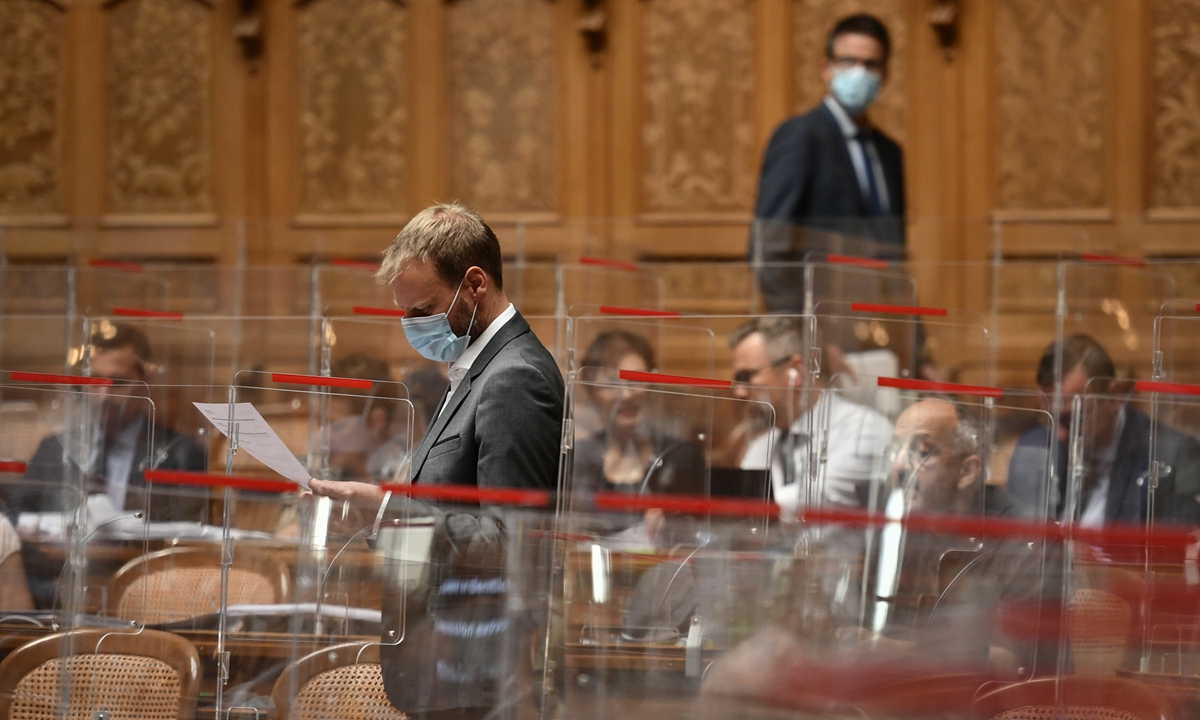 Members of Parliament wearing protective face masks attend the autumn session of the Swiss Parliament with new plexiglas dividers in place and pandemic-related legislation up for debate, amid the COVID-19 outbreak in Bern, Switzerland on Tuesday. Photo: AFP