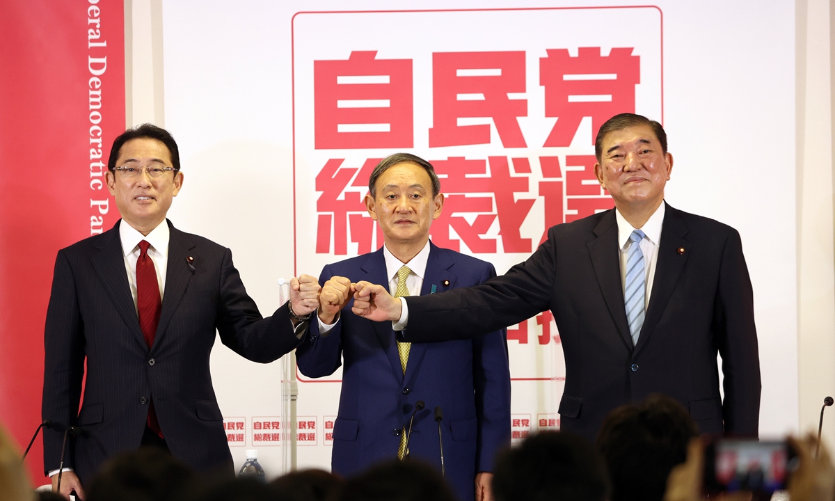 Japan's ruling Liberal Democratic Party leadership candidates Japan's Chief Cabinet Secretary Yoshihide Suga (center), former defence minister Shigeru Ishiba (right), and former foreign minister Fumio Kishida pose for photographs during a news conference in Tokyo on Tuesday. Photo: AFP